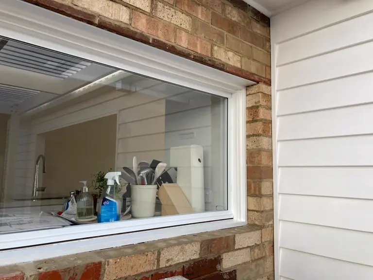 Crisp white painted window trim on a brick home